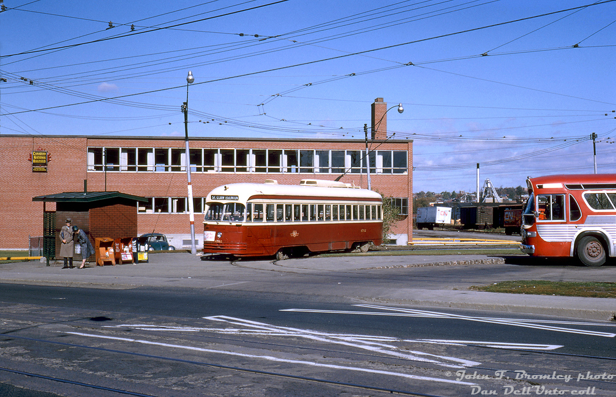 TTC PCC 4762, a secondhand A14-class car originally built for Kansas City in 1946, lays over at Keele Loop off Weston Road (just to the north of St. Clair Ave. and Keele) at the end of its run across town on St. Clair Avenue. A pair of passengers appear to be waiting patiently at the streetside bus stop for the next northbound 41 Keele or 89 Weston bus, near the newspaper boxes offering riders the Globe & Mail, Toronto Telegram ("Enjoy The Tely") and the Toronto Daily Star. A shiny TTC GM New Look or "fishbowl" bus from the 2985-2999 series (only a few years old at the time), idles inside the loop, possibly on the 71 Runnymede route that connected with the St. Clair cars here.

In the background you can see the CN Express & Telegram building (later becoming a Ford dealership) and some trailers parked out back near the CN West Toronto freight yards. Compare this photo to one taken in 1980 at Keele Loop during its final years of operation: http://www.railpictures.ca/?attachment_id=31781

John F. Bromley photo, Dan Dell'Unto coll.