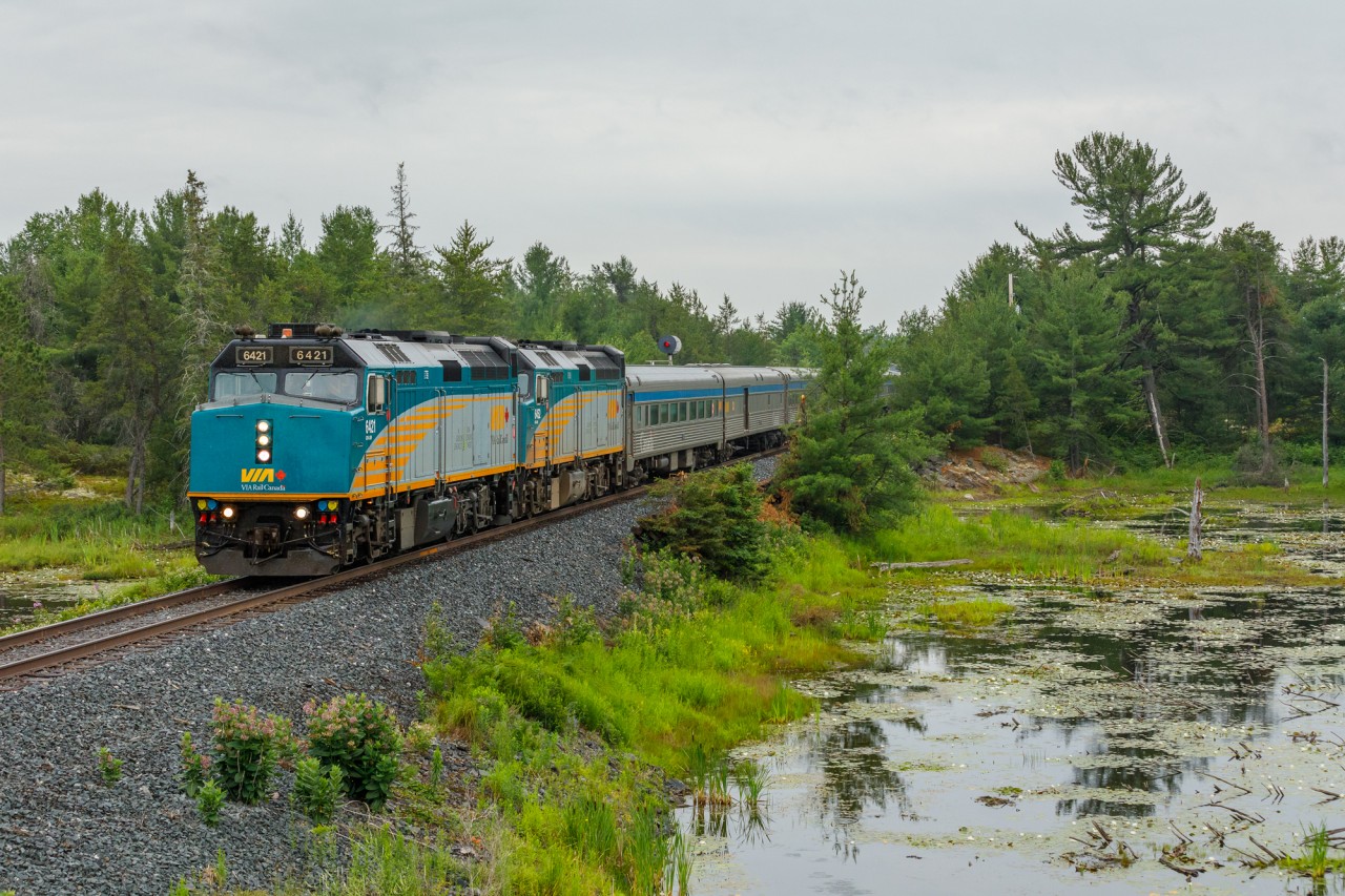 60 kilometres south of their station stop at Sudbury Junction, VIA Rail's flagship train, “The Canadian” is seen racing across the muskeg of Northern Ontario at mile 96.4 of the Canadian Pacific Parry Sound Subdivision. For roughly 130 kilometres, CP’s mainline more or less parallels the Trans-Canada Highway, making for an exciting chase through the beautiful and rugged Shield country. The Canadian, of course, was a fantastic subject to follow on my travels North.