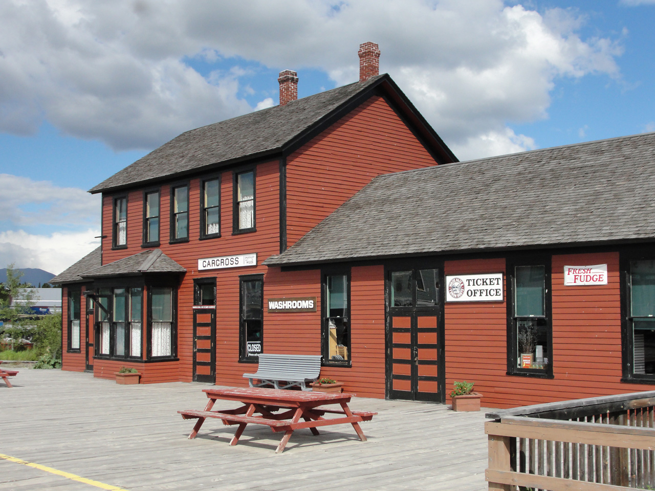 As of 2018 the White Pass and Yukon Route railway station at Carcross Yukon continues to see 5 trains per week in the tourist season, departing noon Tue,Wed,Thu,Fri & Sunday. It's the last stop on in-service track, so 5 northbound arrivals and 5 southbound departures. 
When customers are around expect an OPEN sign here, and in good weather the door beneath the sign "CARCROSS | Skaguay 67.5 miles" may be propped open by a man sized moose-like figure in a lumberjack shirt.