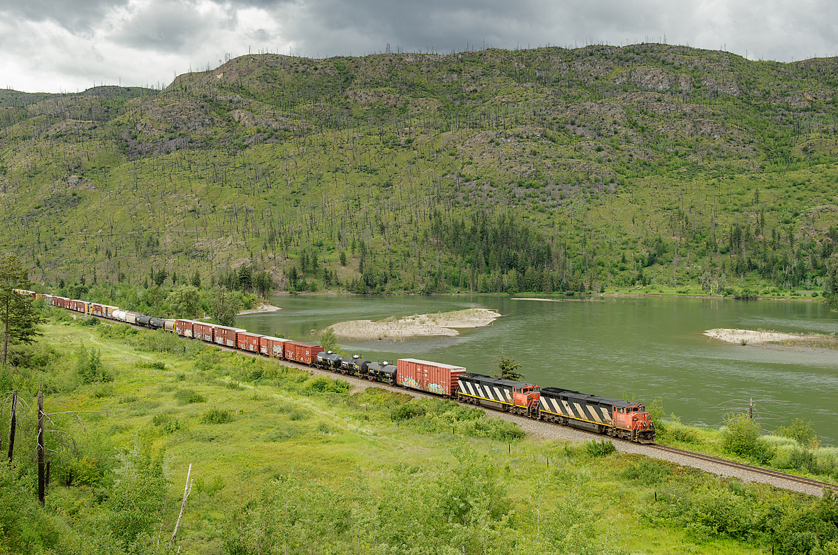 CN C40-8Ms 2417 and 2425 lead a short 58 car Vancouver-Prince George train M354 along the shores of the North Thompson River between Exlou and Barriere on CN's Clearwater Sub.