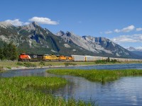 CN ES44AC 2970, GECX C40-8W 9411 and PRLX SD75M 257 hustle 106 loaded autoracks eastbound through Henry House.