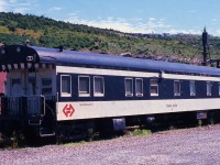 BUSINESS CAR BASKING. TerraTransport's Business Car 'Terra Nova 2' is seen basking in the hot sun of August 7, 1988. Originally built in May 1955 as the 8-Section, 1 State Room, 1 Smoking Room sleeper # 317 'Bonavista' by the CC&F, it was the last narrow gauge sleeping car ordered for the CNR's Newfoundland operations. A vital part of the 'Caribou's' consist, and delivered in all olive green livery, it would be repainted later in olive, black and gold and again in the black and grey before the end of passenger service in 1969. With the formation of TerraTransport in 1979, it was converted to a business car at a cost in excess of $250,000, complete with mahogany walls, a new observation platform and marker lights. While technically still on active duty at the time of this photo, with 7 weeks before the shutdown, it would never again ride the rails in revenue service. Having been sold and resold several times, including as a main attraction at the Trinity Loop Train Park where it could be rented for the night, it eventually found its way to the Orangedale Railway Station Museum in Nova Scotia where it remains to this day.