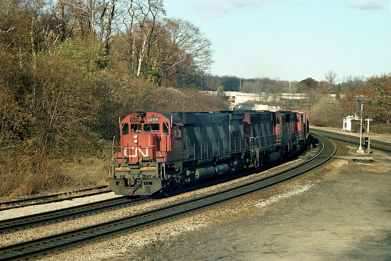 Always enjoyed an MLW leader. Here is M-636 #2306 leading a pair of GP-40-2 wide cabs around the bend at Bayview, heading westward. Trailing units are CN 9500 and 9652; both also now gone from the roster. All the M-636s have been gone 20 years at least, the GP 9500 went to MBTA (Mass Bay Transit) as their 1118 in 1997, and the 9652 in 2000 went to Guilford as their MEC 512. I miss the days back when we were welcome to park the car, wander around (NOT over the rails) and enjoy our hobby within limits of the Junction.