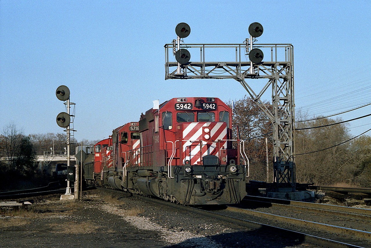 This is one of those shots that turned out a lot nicer than I figured it would. It is getting into the later afternoon and usually the sun has made a run for it by the time the Starlite shows up. But today, it was early, as it sometimes was on Sundays, no TH&B power aboard, alas...   But still, CP 5942, 5718 and 8152 make for a nice scene as it rolls by the area we used to be able to park at many years ago. I looked up CP 8152 in the CTG as the number did not register with me. No wonder. It was re-manufactured into 1274 by 1986 and then became Control Cab 1153 in 2004. It is gone now. You very well may be shaving with it.
