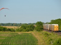 Photographed on CRHA Niagara's "Longest Day" event in 2016 (a 37 year tradition to go out rail-fanning on the Friday closest to the longest day of the year); we couldn't help but admire the ingenuity of this railfan's method of getting a more interesting photographic angle by using a powered parachute. Train itself was CN 2299 and 2512 followed by a long line of mostly autorack cars. 