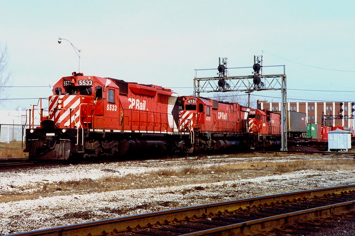 Dreams come true at West Toronto. 5533, 4701 and 4505 bang across the CN Weston Sub diamonds (now replaced with a grade separation)heading for London...or possibly Hamilton via the Canpa Sub. Those were very different times around railroads; waves were the most common interaction.
