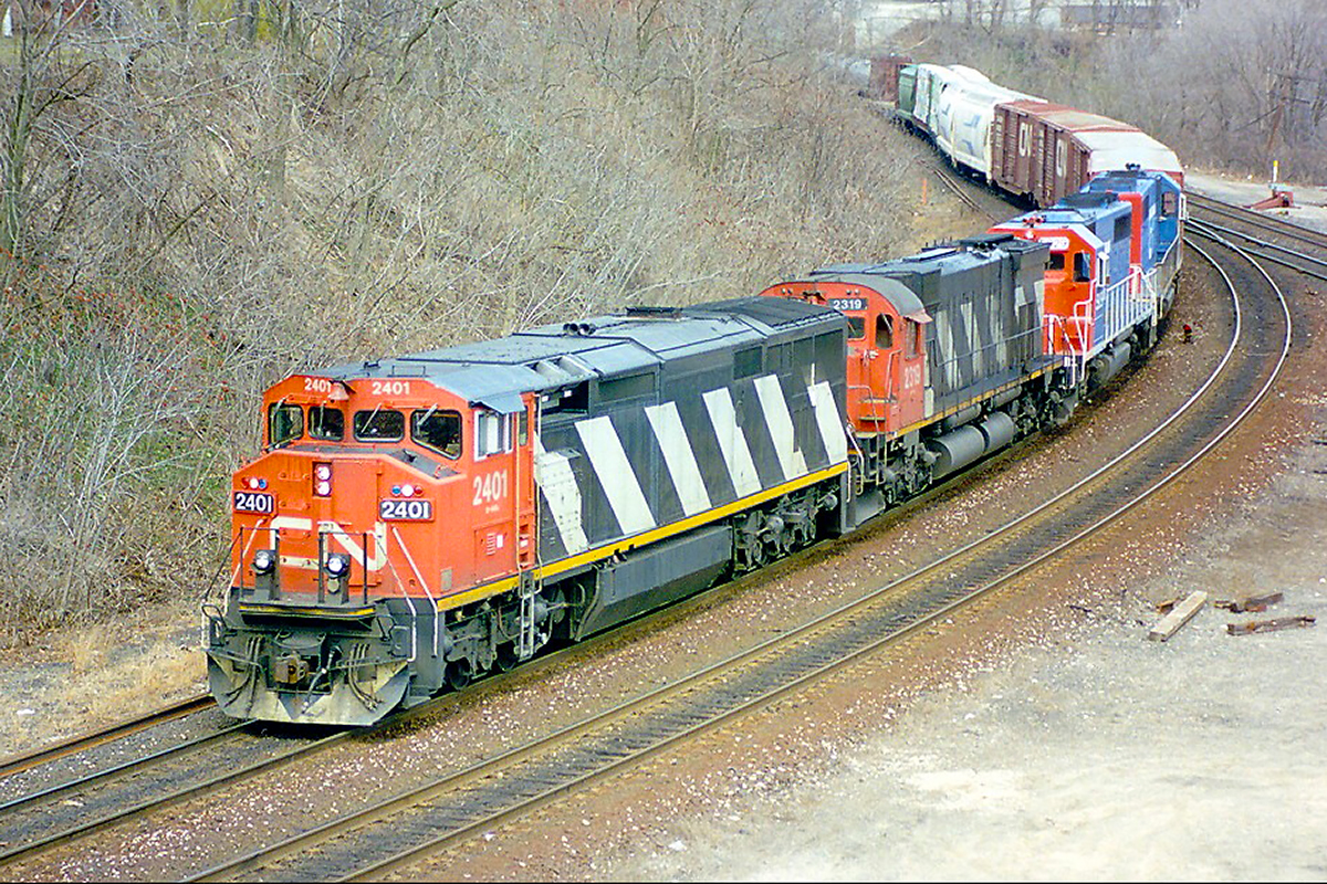There were brief times in the early 90's when you might catch power from 3 builders on the same train.Here GE C40 2401 leads M636 2319 and 2 unknown GTW SD40's making the turn onto the Dundas Sub at less than the stated 15mph. The train had waited at Bayview for a few minutes to be scooped by 239; the "Laser" to Chicago. Those were the days.