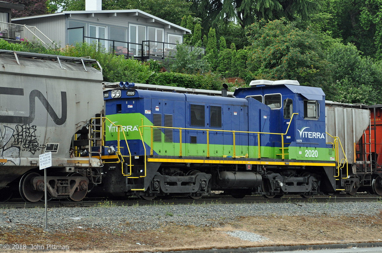 VITX 2020 is an NRE 1GS7B genset locomotive, with one Cummins QSK19C low emissions diesel rated at 700 HP. This is NRE's smallest and lowest-power switcher.  This one is equipped with AAR type A switcher trucks. 
Viterra is a major grain elevator operator at the Port of Vancouver. It has its own locomotives and crews to move cuts of grain hoppers as required, including spotting them for unloading at their elevators.