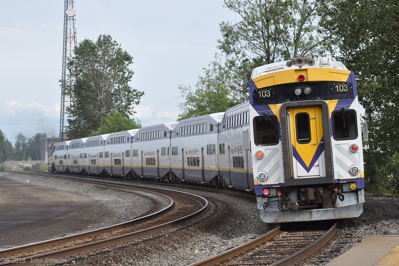 A West Coast Express F59PHi is leading 8 Bombardier bilevel coaches on WCE's second weekday afternoon service, the 4:20 PM departure from Vancouver Waterfront station making all station stops to Mission City.  When the train returns to Vancouver next weekday morning, Bombardier BiLevel cab car WCE 103 will lead. In this picture it is seen at the back of the 8-car train departing WCE Port Coquitlam station around 4:58 PM, a few minutes later than scheduled.