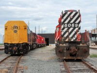 A pair of different dash 2 models, rear views of CSX F40PH-2 9998 and CP SD40-2 6069.