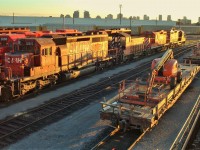 A late December afternoon on the west end has STL&H 5615,SW1200rs slug 1023,GP9 slug 1025, GP9 1518 and a pair of flat cars with boom lifts from working on the Diesel shop's rebuilding process.