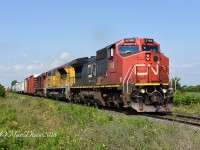 CN 394 lead by CN 2306 with trailing units ElectroMotive DEMO 1606 and IC 1008 head east bound out of Sarnia at Fairweather Sideroad.