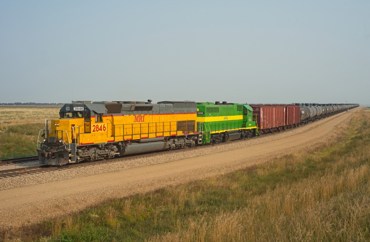 With 110+ loads on their drawbar, a couple modern day critters are seen repositioning a crude oil train within the loading terminal.