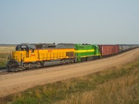 With 110+ loads on their drawbar, a couple modern day critters are seen repositioning a crude oil train within the loading terminal.  