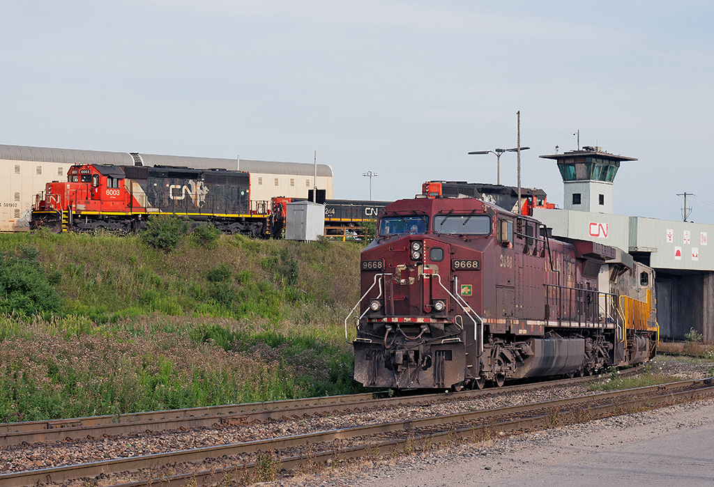 Who's Railway Is This?! The competition has showed up to Mac Yard leading CN 394, the incoming crew now heads to the shops ducking under the hump while an SD40 hump set awaits it's next assignment.