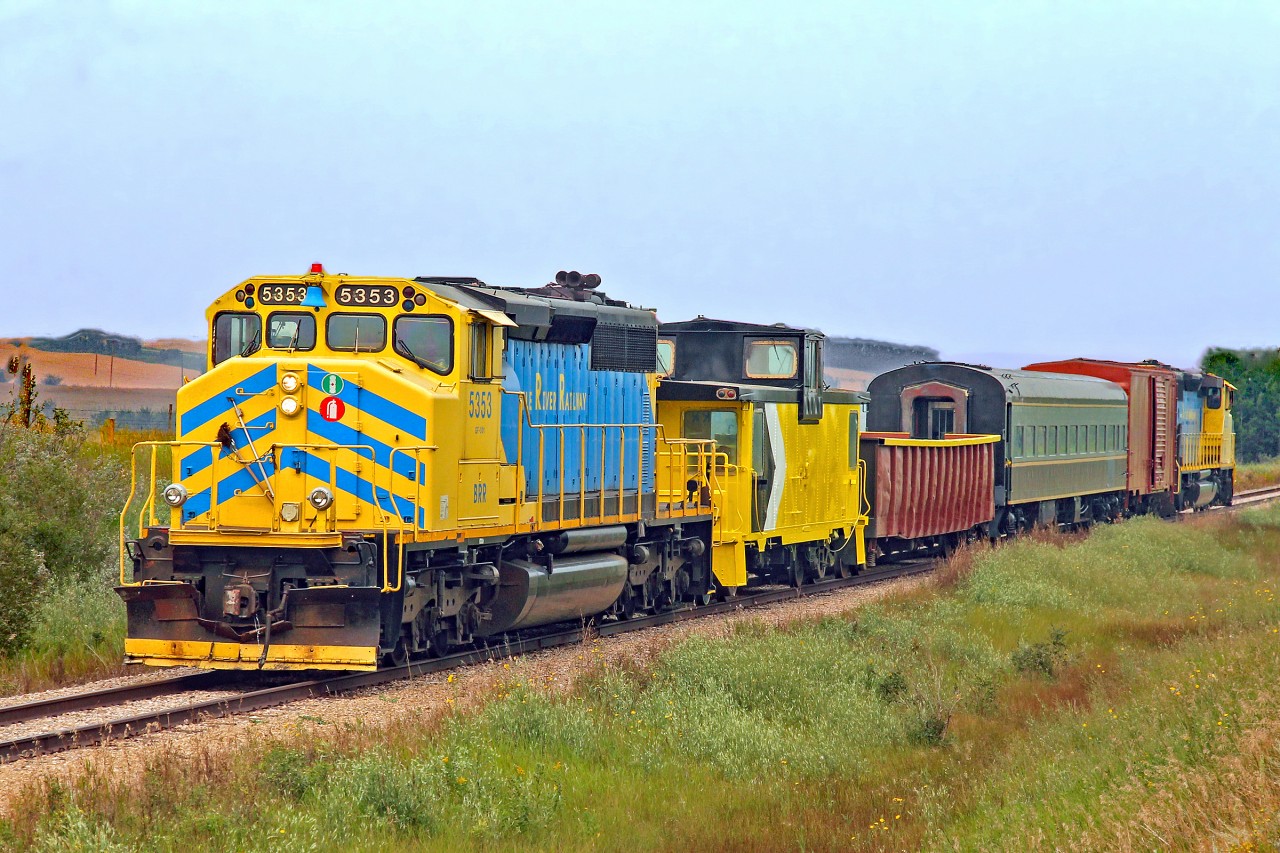 The sun is trying to break through the BC smoke as BRR locos 5251 and 5353 depart Alliance with a "Friends of Battle River Railway" passenger excursion train to Heisler