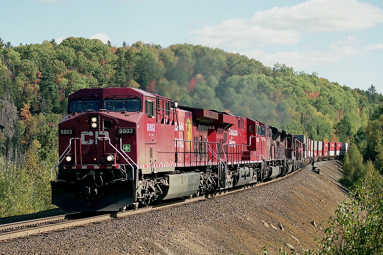 Trains were backed up on the 'Superior' route due to a derailment up near Coldwell-Marathon area, I think it was, and so some trains were doubled; witness this long string of power on one of the first westbounds on the move; CP 9803, 8803, 9133, 9114, 6016, 5957, 9013 and 9122. I was caught a bit off guard and this was the best I could do; the train is approaching the Marina Rd crossing, and I didn't have the time to scoot back toward Windy Lake ....... and the sun angle was tough.......