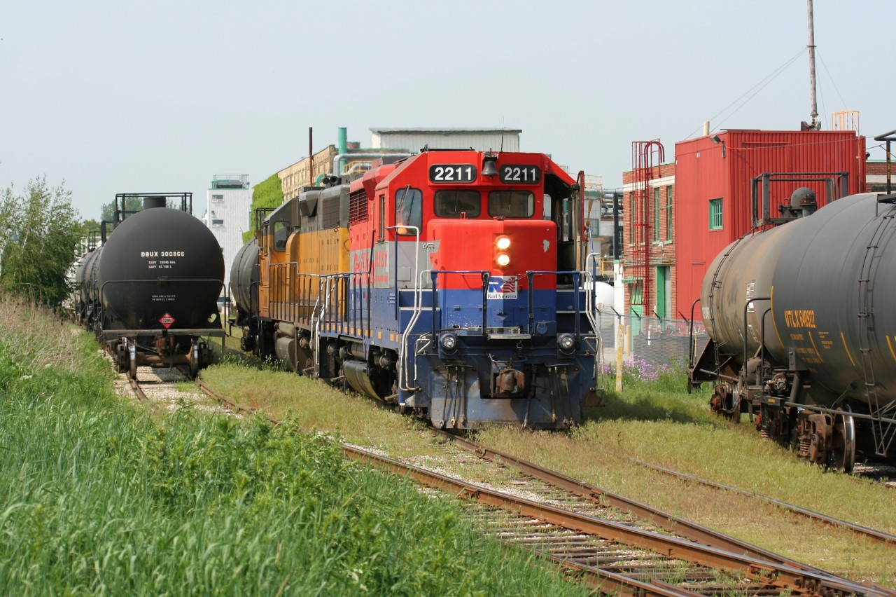 RLK GP35 2211 (painted for RailAmerica) and LLPX GP38AC 2210 are seen assigned to Goderich-Exeter Railway train X580 in Elmira, Ontario as they switch the chemical companies on the Waterloo Spur. It was reported recently that RLK GP35 2211 was scrapped in Goderich, Ontario during August by G&W. The unit was originally Canadian Pacific 5010, nee- Canadian Pacific 8210.