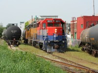 RLK GP35 2211 (painted for RailAmerica) and LLPX GP38AC 2210 are seen assigned to Goderich-Exeter Railway train X580 in Elmira, Ontario as they switch the chemical companies on the Waterloo Spur. It was reported recently that RLK GP35 2211 was scrapped in Goderich, Ontario during August by G&W. The unit was originally Canadian Pacific 5010, nee- Canadian Pacific 8210. 
