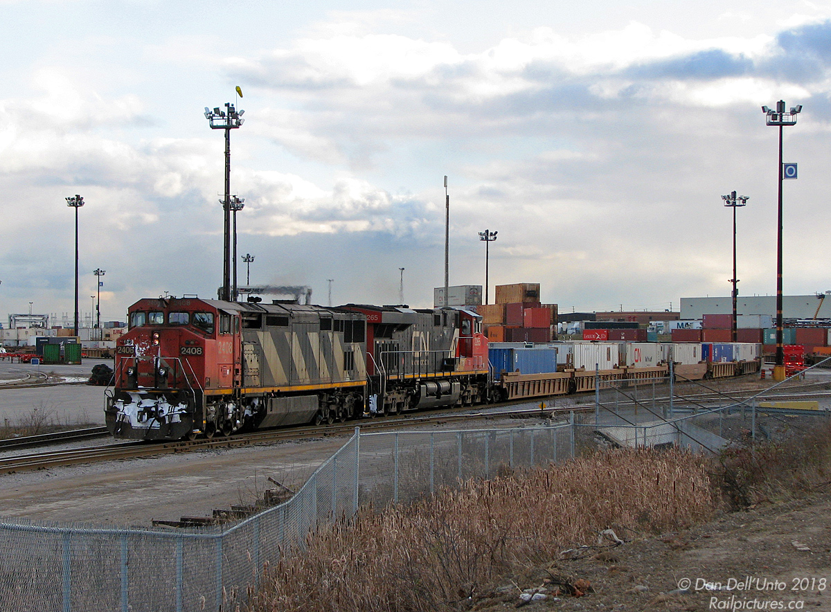 CN C40-8M "Saggin' Wagon" 2408 and newer ES44DC 2265 switch the north end of Brampton Intermodal Terminal on train #149, likely having just arrived inbound on its Halifax-Montreal-Chicago journey westward. I believe standard operating procedure after yarding their train was to send #149's power light from BIT to MacMillan Yard, and new freshly shopped power would head over to BIT later for #149's departure after BIT was done shuffling off/on the local container traffic.