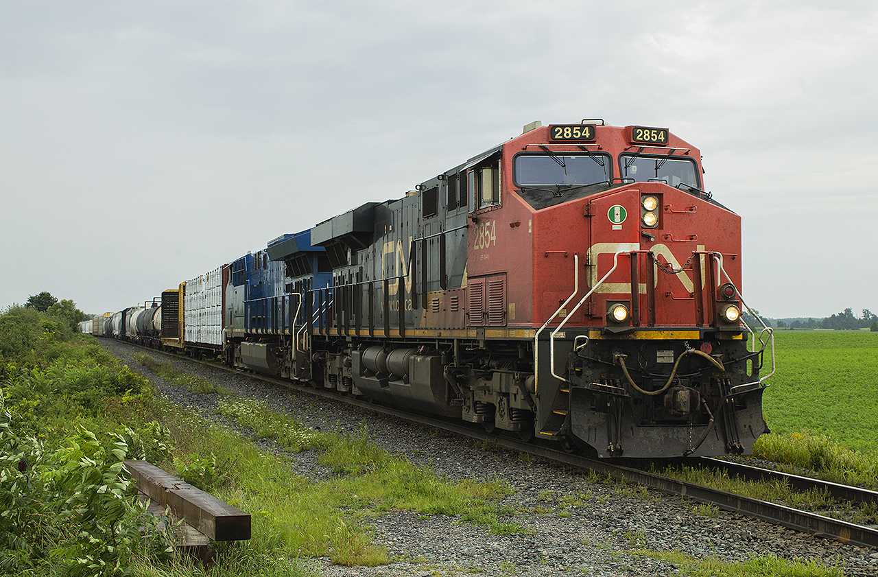 After seeing VIA's 40th Anniversary train down on the waterfront in Sarnia, I took advantage of the extra time I had while my daughter had her nap! Hoping to catch something on the old Stathroy Subdivision, I ended up o Camlachie Road. In the distance I faintly spotted a yellow signal lined for a westbound to Sarnia. Not long after, my patience paid off in the form of this CN freight with GECX 2037. After coming through Wyoming and rounding the bend for the home stretch, it slowed to a stop as if the crew had known I had wanted to do a photo shoot of the train. Not everyone who was stopped by the train shared my delight. But for me, it reminded me of what the Strathroy Subdivision used to be as a kid...double tracked with both freights and passenger trains in either direction.