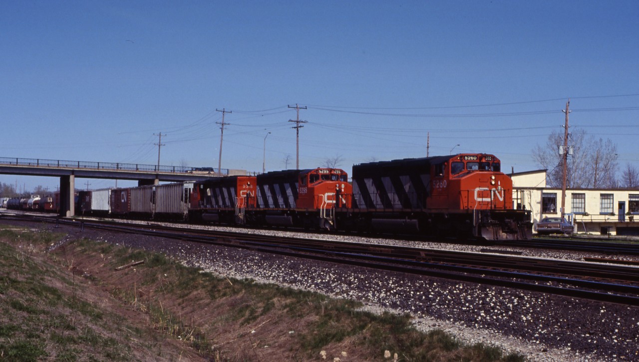 A trio of SD40-2Ws (5260, 5295, and 5318) lead a westbound past Aldershot Yard.