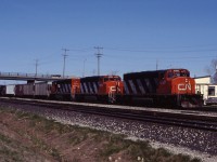 A trio of SD40-2Ws (5260, 5295, and 5318) lead a westbound past Aldershot Yard.