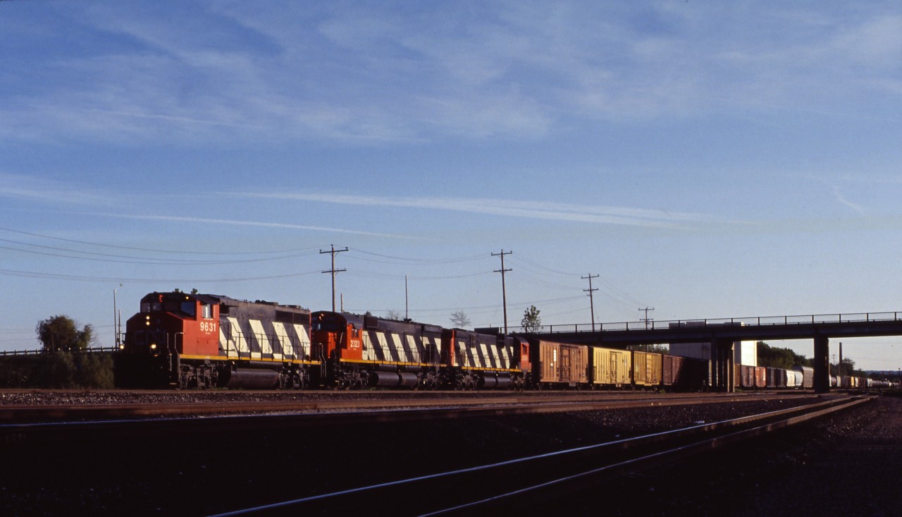 CN GP40-2LW 9631 leads a couple of MLW "Big C's" (M636 2323 and C630m 2009) through Aldershot on a fine May evening in 1993. While large blocks of reefer traffic are now a thing of the past, the railway is still handling a bit of this traffic out of Chicago--as evidenced by the two cars on the head end.