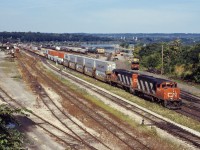 We don’t normally associate double-stack container trains with Hamilton and the Niagara Peninsula; however, from February 1989 until double stack clearance projects were completed through Western Canada in the early 1990s, CN operated double-stack service between Toronto and Vancouver via Buffalo. Initially 12 “5-pack” car sets were leased from TTX. Later in the year (July 1989), Maersk introduced service between Tacoma, Washington and Toronto/Montreal, also via CN in the Niagara Peninsula and NS west of Buffalo. Two units typically handled this train--today, a pair of GP40-2Ws (9633 and 9659).