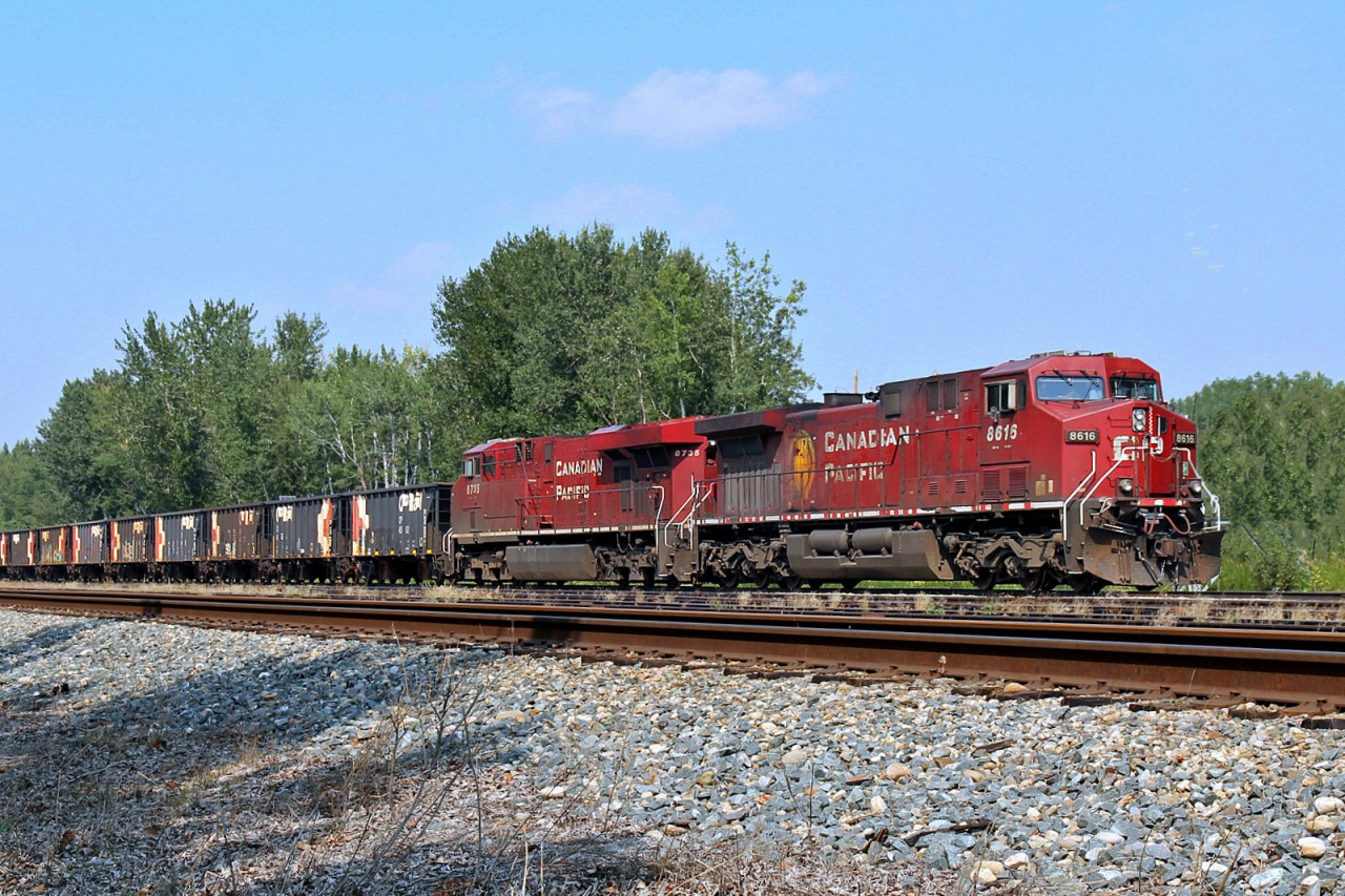 AC4400CW CP 8616 and ES44AC CP 8735 sit idling in the siding at Wetaskiwin waiting to depart with their work train.