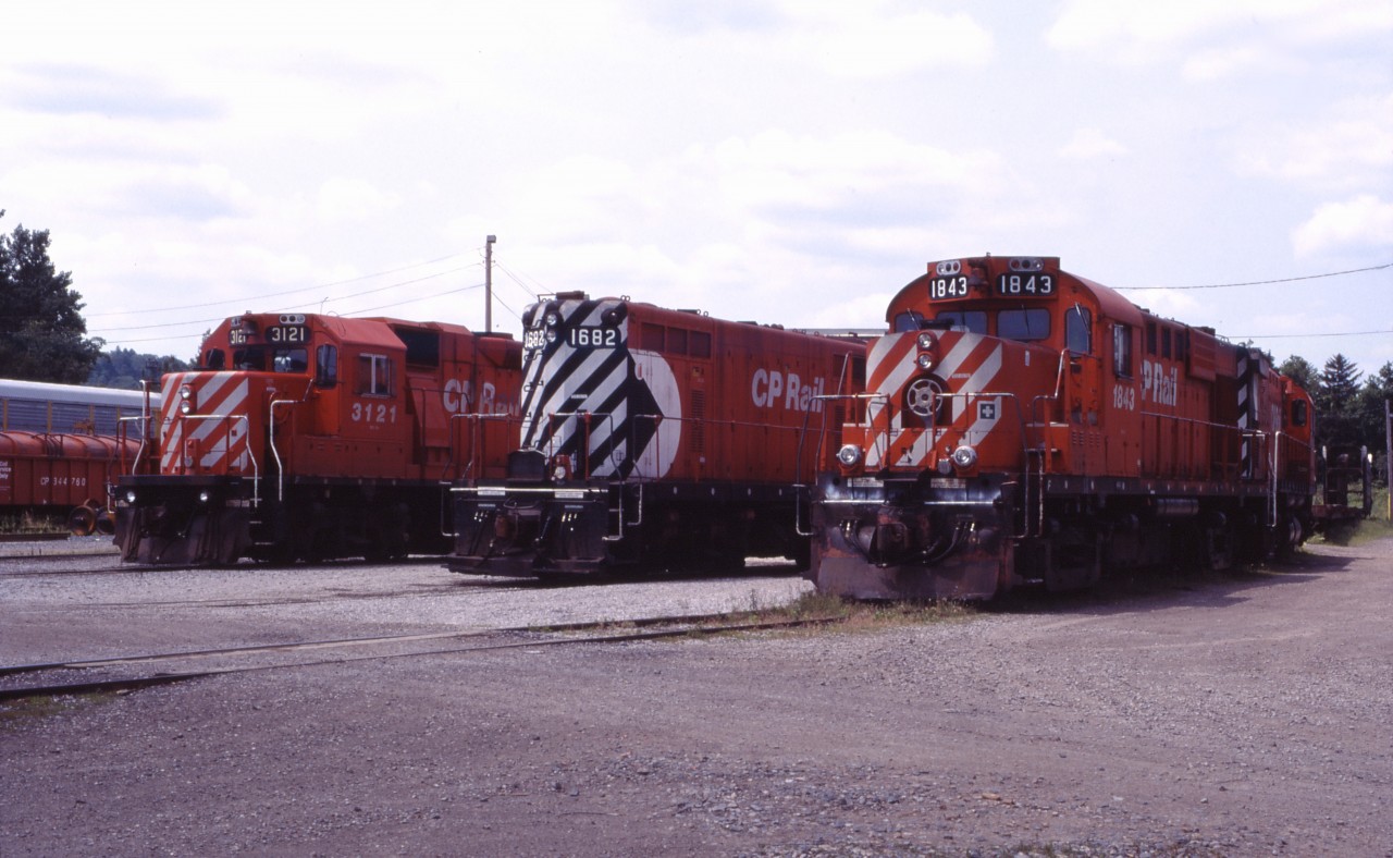After closure of the TH&B's Chatham Street roundhouse, for a while in the 1990s, CP motive power in Hamilton was serviced at the former TH&B car shop near Aberdeen Avenue. Here we have GP38-2 3121, GP7u 1682 (rebuilt from TH&B GP7 72), RS18u 1843 and an unidentified C424 waiting for their next assignments. Such power was typical on the Hamilton sub prior to the invasion of SD40-2s and AC4400CWs a few years later.