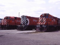 After closure of the TH&B's Chatham Street roundhouse, for a while in the 1990s, CP motive power in Hamilton was serviced at the former TH&B car shop near Aberdeen Avenue. Here we have GP38-2 3121, GP7u 1682 (rebuilt from TH&B GP7 72), RS18u 1843 and an unidentified C424 waiting for their next assignments. Such power was typical on the Hamilton sub prior to the invasion of SD40-2s and AC4400CWs a few years later.