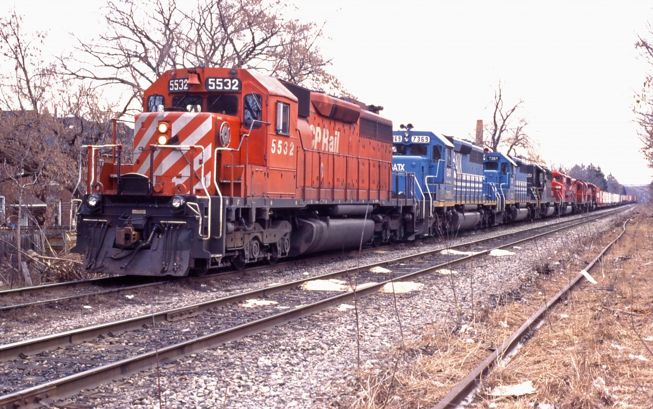 In this age of minimum power on trains, it is hard to believe what we used to see (even if the train was deadheading power).

Take this CP northbound at Kinnear yard in Hamilton--we have CP SD40 5532, a pair of leased GATX SD40-2s (7369 and 7362), former NS SD40-2 3254, SOO SD60W 6061, GP9u 8239, RS18u 1823, and SD40 5510. Now, will he be going north on the Ham sub or east on the Oakville?!?!? (Likely east to Toronto Yard...let's head for Bayview or Aldershot!)