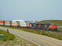 On yet another smokey day in Alberta a pair of ES44ACs, CN 2828 and 3813 pilot Train 114 through Clover Bar.