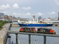 CN 7054 & CN 4707 are entering the port light power to pick up some cars in interchange from the Port of Montreal. In the background is the cable ship <i>IT Intrepid</i>.