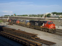 A late CN 401 has a lot of power (CN 2867, CREX 1516, CN 2435, IC 2725 & CN 7032) as it passes by Turcot West. The right of way that it is traveling on is supposed to replaced by a new right of way that curves to the left by the end of the month. Already one of the four tracks here (the transfer track) has been removed here.