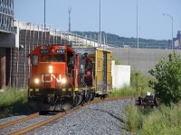 With a single boxcar for the Kruger plant, the Pointe St-Charles Switcher with CN 4707 & CN 7054 for power is stopped near the Notre-Dame crossing on the rarely used Turcot Holding Spur, waiting for a crewmember to walk up to the power after throwing the switch.