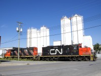CN 7054 & CN 4707 are shoving a hopper and a boxcar towards the end of the Turcot Holding Spur.