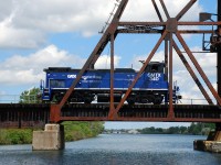 After spending most of the morning switching around Feeder, GMTX 340 trundles across the old Welland Canal heading back towards Dain City.  GMTX 340 recently arrived on the Trillium Railway to replace GMTX 333 that was transferred to the Orangeville-Brampton Railway.  GMTX 340 wears a darker shade of blue than GMTX 333.