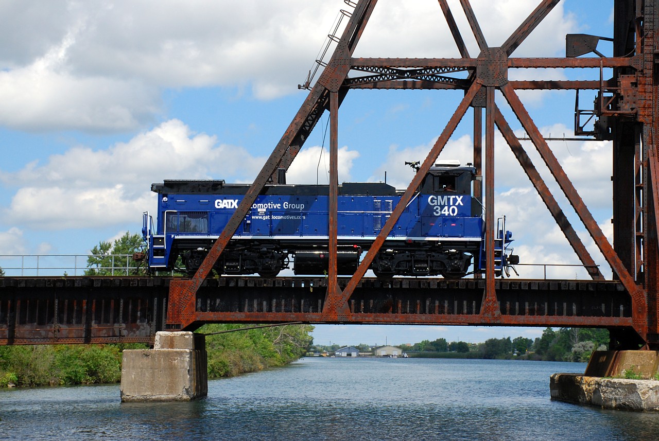 After spending most of the morning switching around Feeder, GMTX 340 trundles across the old Welland Canal heading back towards Dain City.  GMTX 340 recently arrived on the Trillium Railway to replace GMTX 333 that was transferred to the Orangeville-Brampton Railway.  GMTX 340 wears a darker shade of blue than GMTX 333.