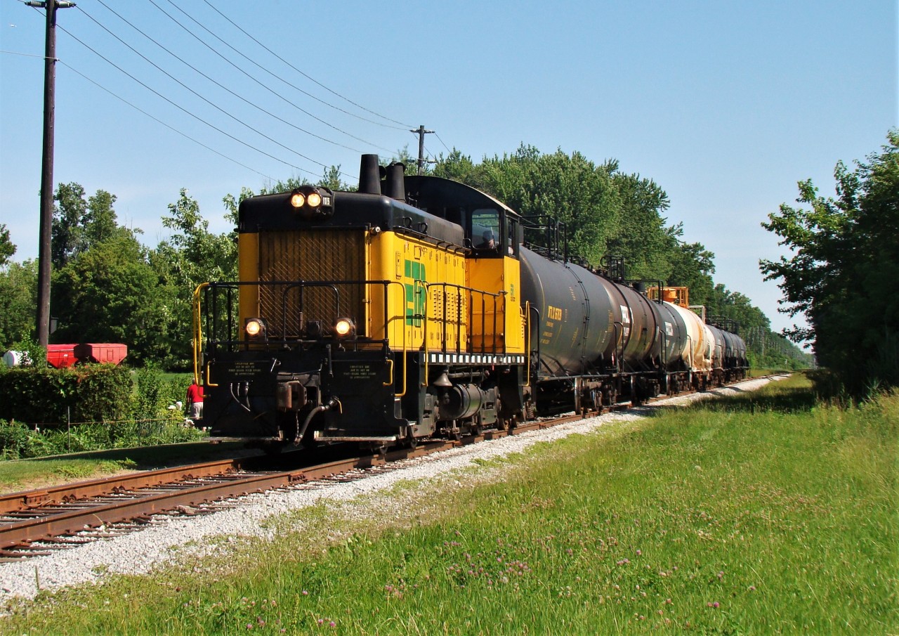 Essex Terminal SW9 #105 is seen here heading south through Lasalle en-route to Amherstburg with 6 cars for Honeywell and 3 for Diageo. In the summer of 2013, Honeywell shut down their operation in Amherstburg where they made hydrofluoric acid thus cutting freight on this local. Diageo is still a customer however and is currently switched about twice a week.