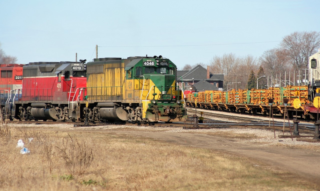 Goderich-Exeter Railway train 432 with GEXR GP40’s 4046, 4019, RLK GP35 2211 and RLK GP40 4096 is seen putting it’s train together in the yard at Stratford, Ontario as train 516  waits to head west by the station with GP38 3821.