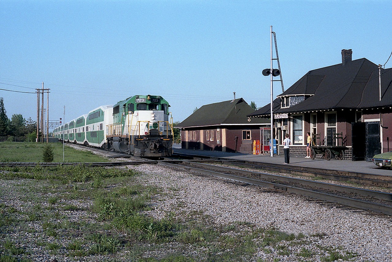 Nothing special for this time frame, I guess you could say, but I liked this image because it is actually one of the very few I have which includes the late day sun without any train actually blocking a clear view of the old Freeman station. The scene is basic and free of clutter. GO 723 is making the evening run to Hamilton, and GO 901 is the APCU on the eastward end of the train. The MoW building is gone and the station has been moved and preserved a short distance away on Fairview Av. This view is now empty save for weeds.