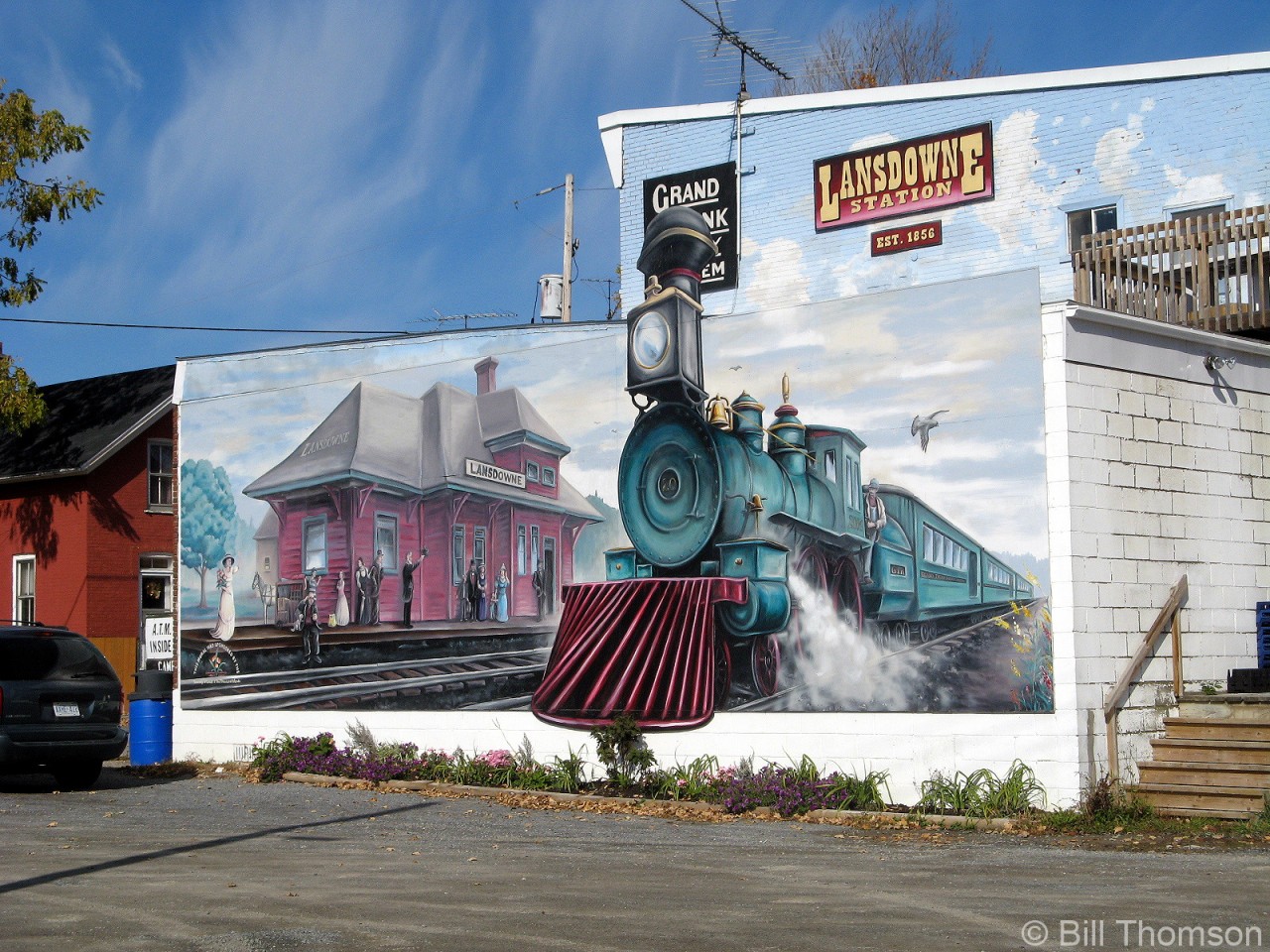 An interesting mural on the side of a store by the tracks in Lansdowne Ontario (21 miles west of Brockville), depicts a steam-powered passenger train passing the old Grand Trunk Railway Lansdowne Station, which would have been located just across the street along the present-day CN Kingston Sub. There was a severe CN train wreck in front of Lansdowne station on February 25th 1962 where one of the derailed boxcars involved smashed into the end of the station, damaging it badly enough to result in the structure being torn down that same year.