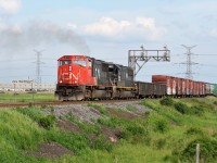 An eastbound CN train with SD75I 5717 and IC SD70 1021 is seen departing Mansewood on the CN Halton Subdivision, just east of Milton, Ontario after meeting a westbound train with SD40-2(W)’s 5260 and 5331.