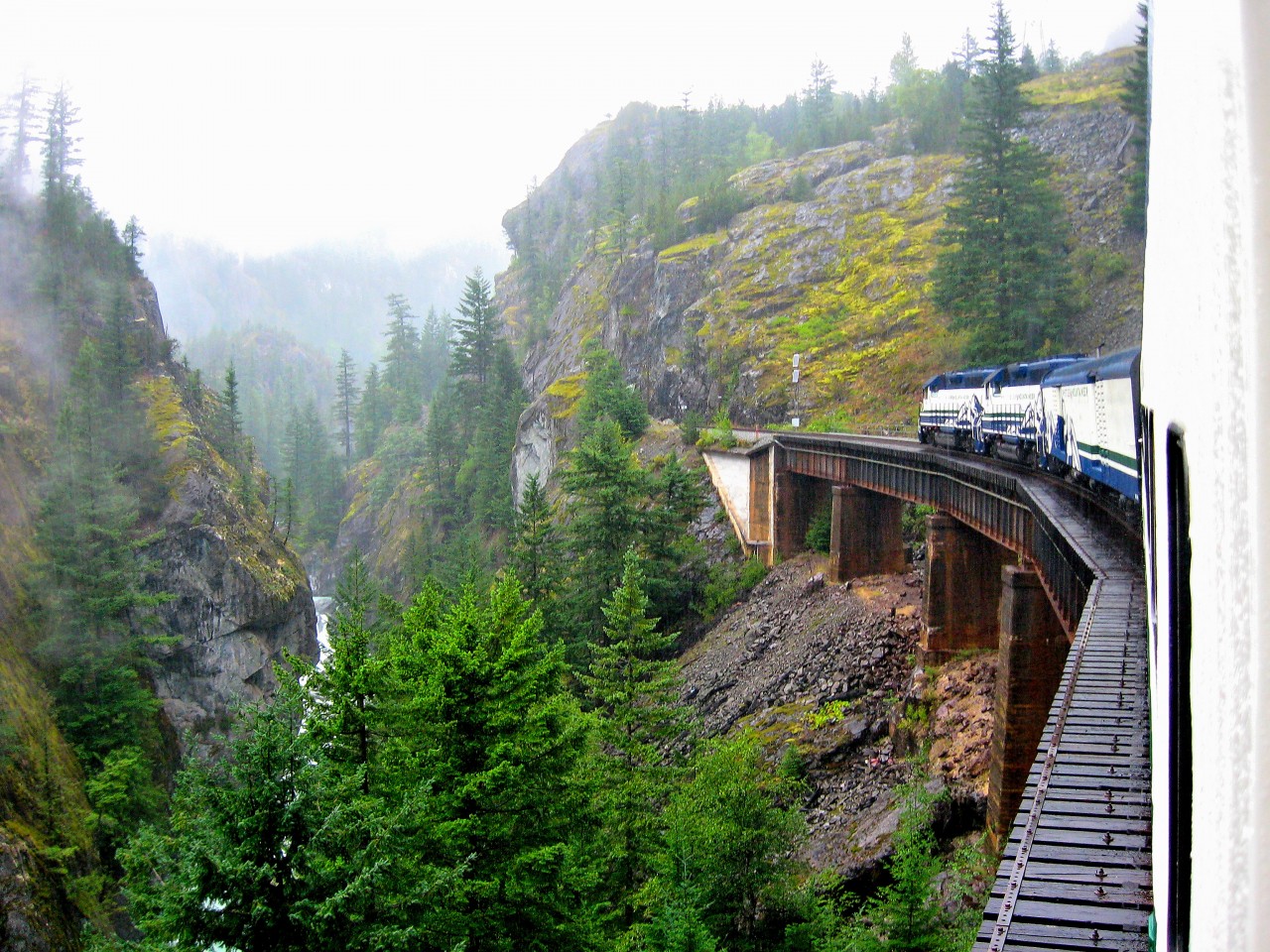 ROCKY MOUNTAIN HIGH. Mist and rain were the order of the day as the Whistler Mountaineer crossed the Cheakamus Canyon Trestle on August 24, 2008. Departing North Vancouver with his oldest son William on a Father-Son trip to Whistler, the photographer was able to capture a part of British Columbia in all its rugged beauty from an open air car as the train climbed some 2000 feet from sea level at Squamish until departure at Whistler.