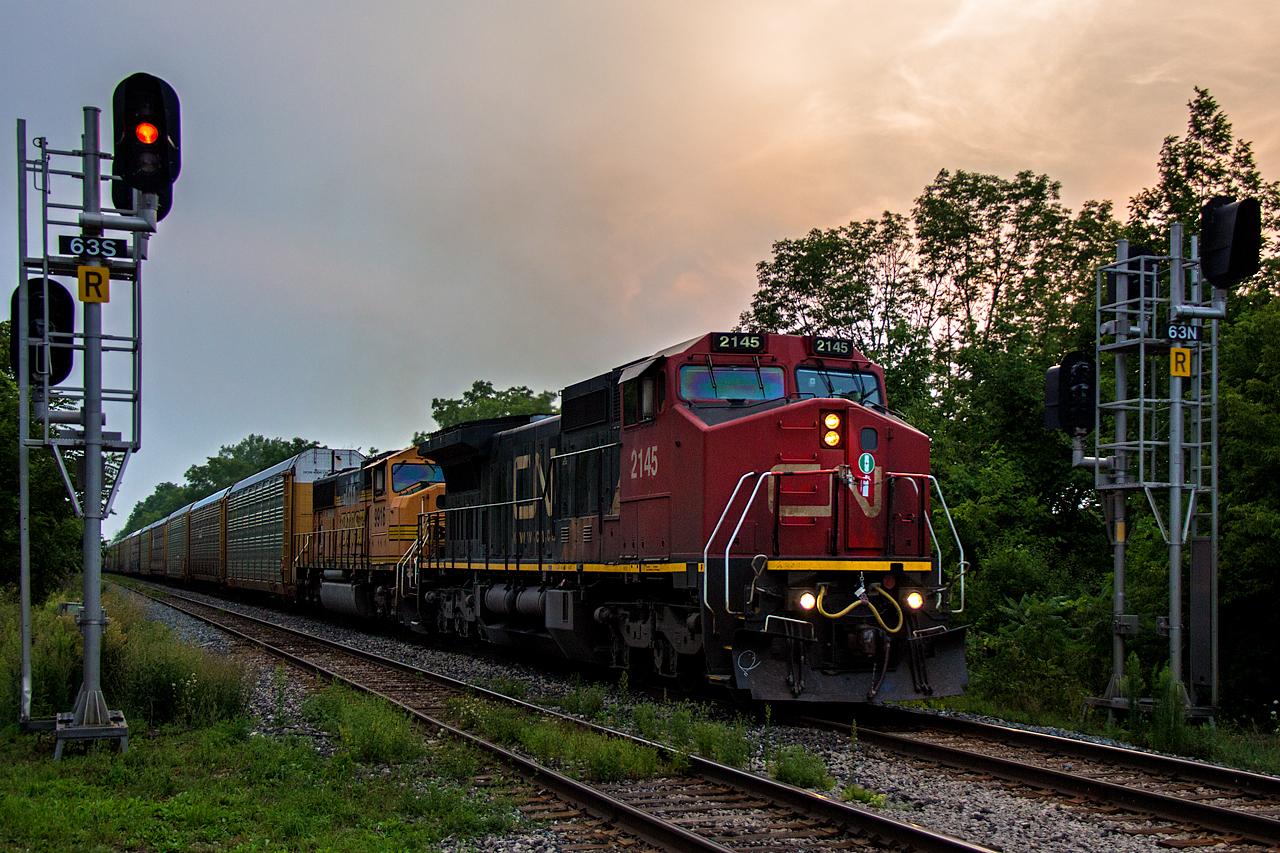 After stopping at Glenridge, CN 330 has gotten back underway up the 1.6% grade into Niagara Falls, passing Garner Road. While leaser power has been common on CN 330, the trailer doesn't show any indications of being leased variety. CN 2145 leads the way, with BNSF 9916 trailing. Older EMD's of any variety under foreign class 1 ownership are pretty rare sightings here nowadays. I don't remember the late 2013-early 2015 foreign power craze bringing any Niagara bound on CN, so this is quite remarkable. 9916 looks like an early EMD relic, but in reality it's just less than 20 years old. All those years hauling coal trains in the midwest have not done the paint well. CN 2145 of course has BNSF heritage as well, so these two units likely have had their share of meets. The AC traction from 9916 seemed to provide a noticeable boost to 330's trip up hill, and the chase to Clifton afterwards was almost unsuccessful because of it.