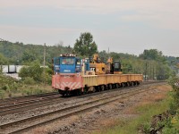 The Georgetown Railway Equipment (GREX) rail cutter, which is all the way up from Texas, sits waiting for CP 246 to pass on its right and CP 241 to pass on its left before it can resume picking up off cuts of rail in Guelph Junction. One crane picks up the rail while the other crane has a rail chopper to cut it to size to fit in the rail cars.