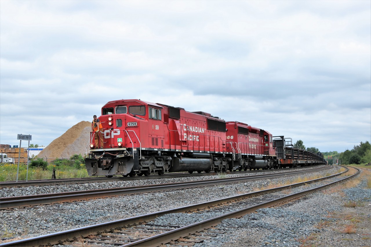 The rail track train has some very nice power in SD60M 6259 and SD40-2 5866 as it rolls in to Guelph Junction with the conductor readying to get off and throw the manual switch to Main 1 where it will tied down and get a recrew.