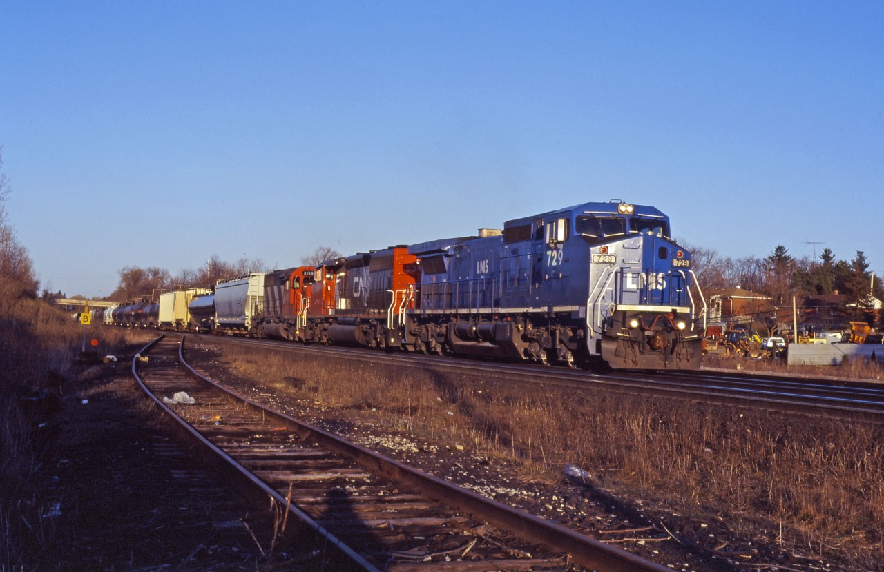 In late 1994, CN entered into an 18-year lease arrangement with LMS (Locomotive Management Services) for 25 C40-8W units (715-739) which were to be on CN lines over the winter months. This arrangement only lasted until spring 1998; however, units 728-739 returned to CN on long term lease in 2001 and were purchased in 2012. These units currently wear CN numbers 2455-2466 and most are still in the original blue paint with a CN logo and "IC style" numbers(except for 2464 which was retired in 2012 after an accident).

In this scene taken during the first lease period, unit 729 leads CN SD40-2W 5349 and SD40 5199 on an eastbound through Copetown.